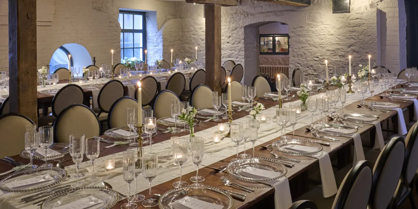 A room adorned with numerous white chairs elegantly decorated with bows.