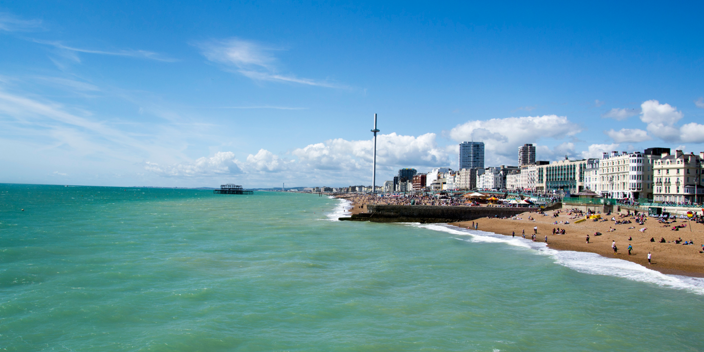 Scenic beach view featuring individuals enjoying the seaside.