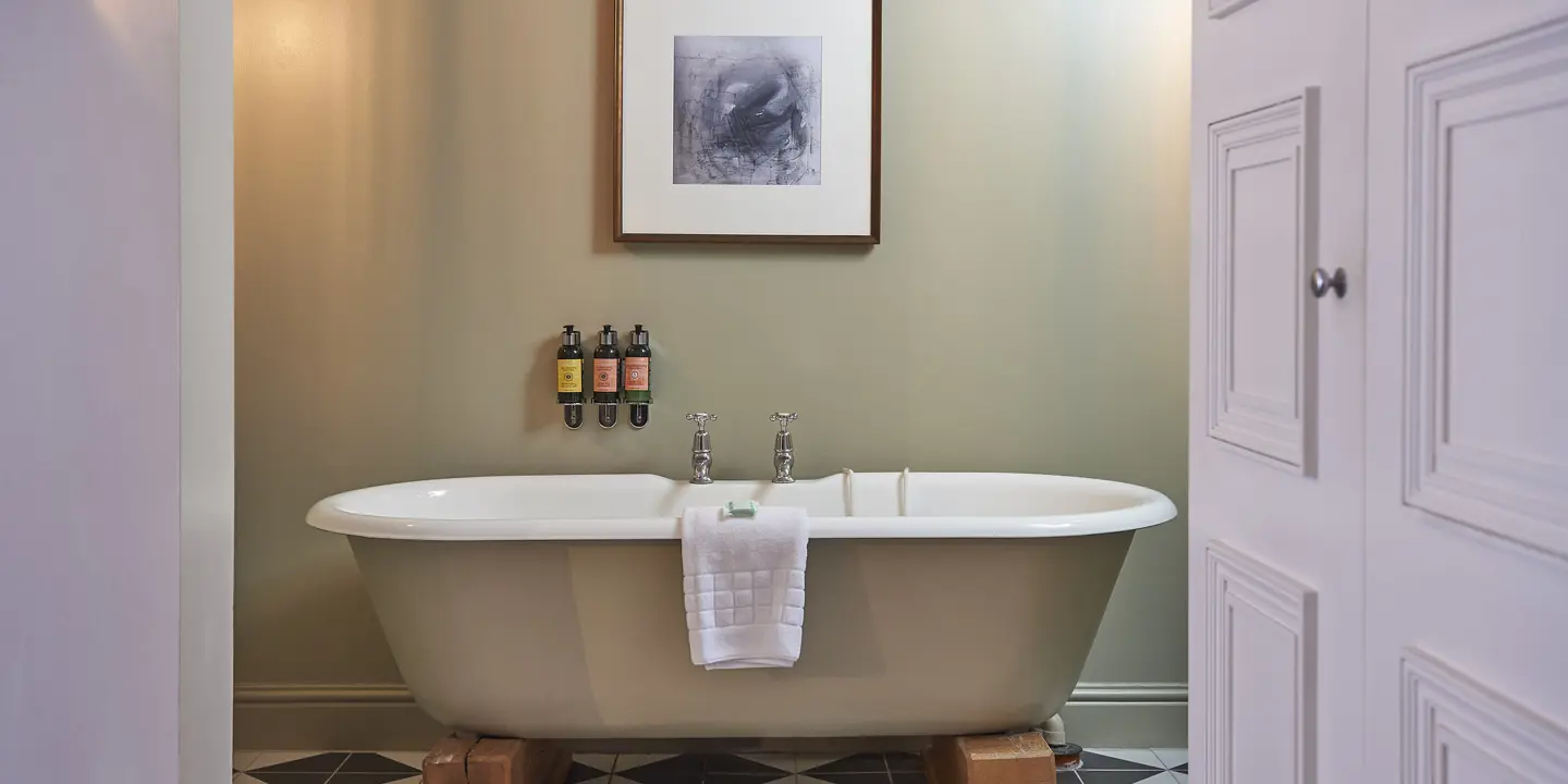 Bathroom with a bathtub positioned next to a doorway.