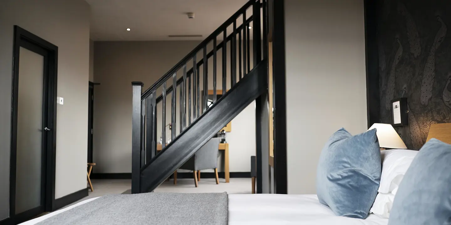 Bedroom with a staircase leading to the second floor.