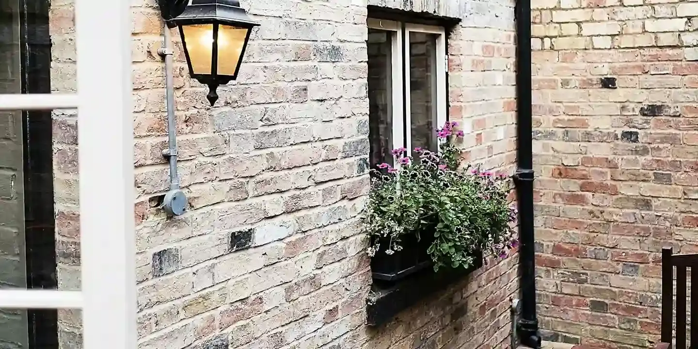 Brick building with a lamp attached to its side.