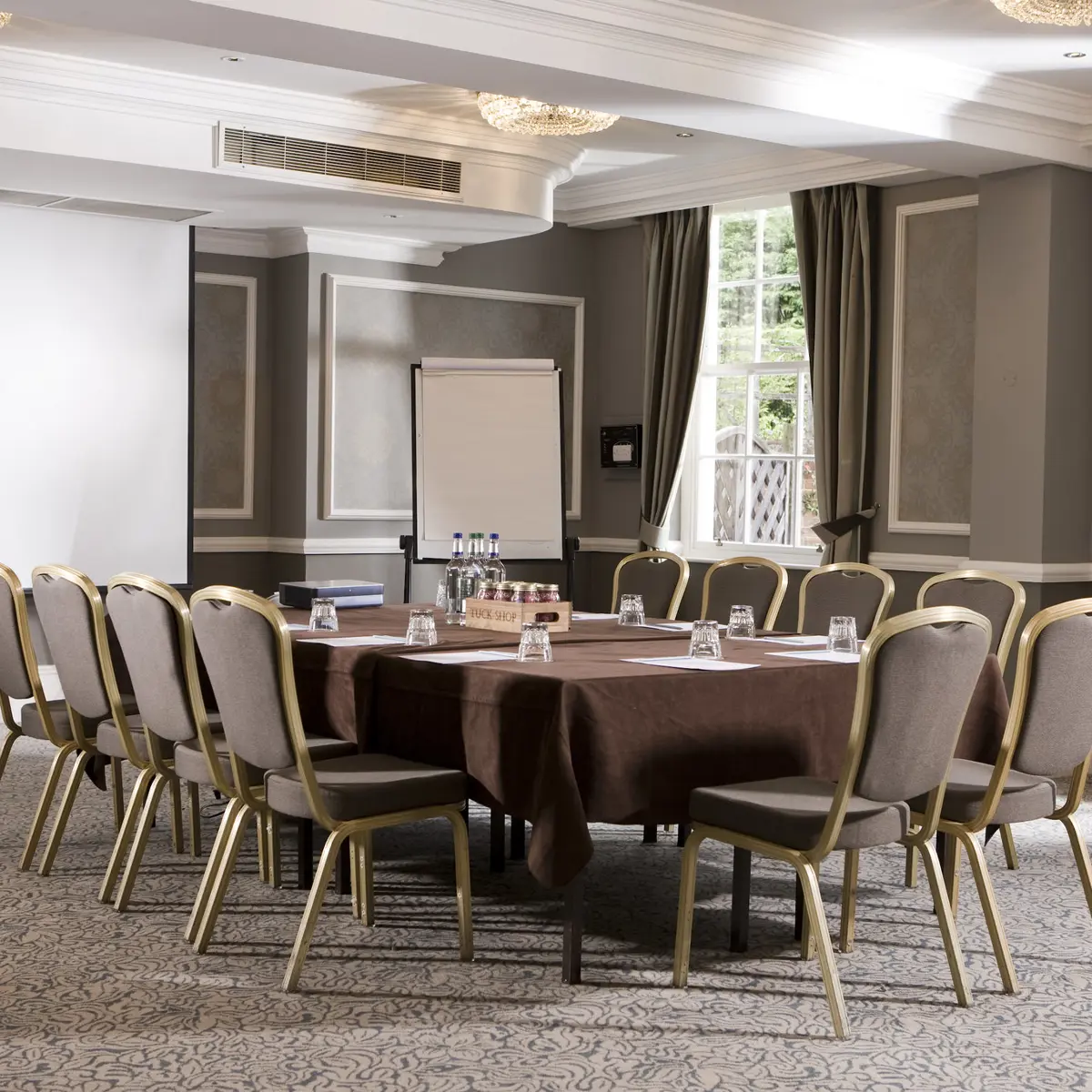 A room furnished with a table and chairs.