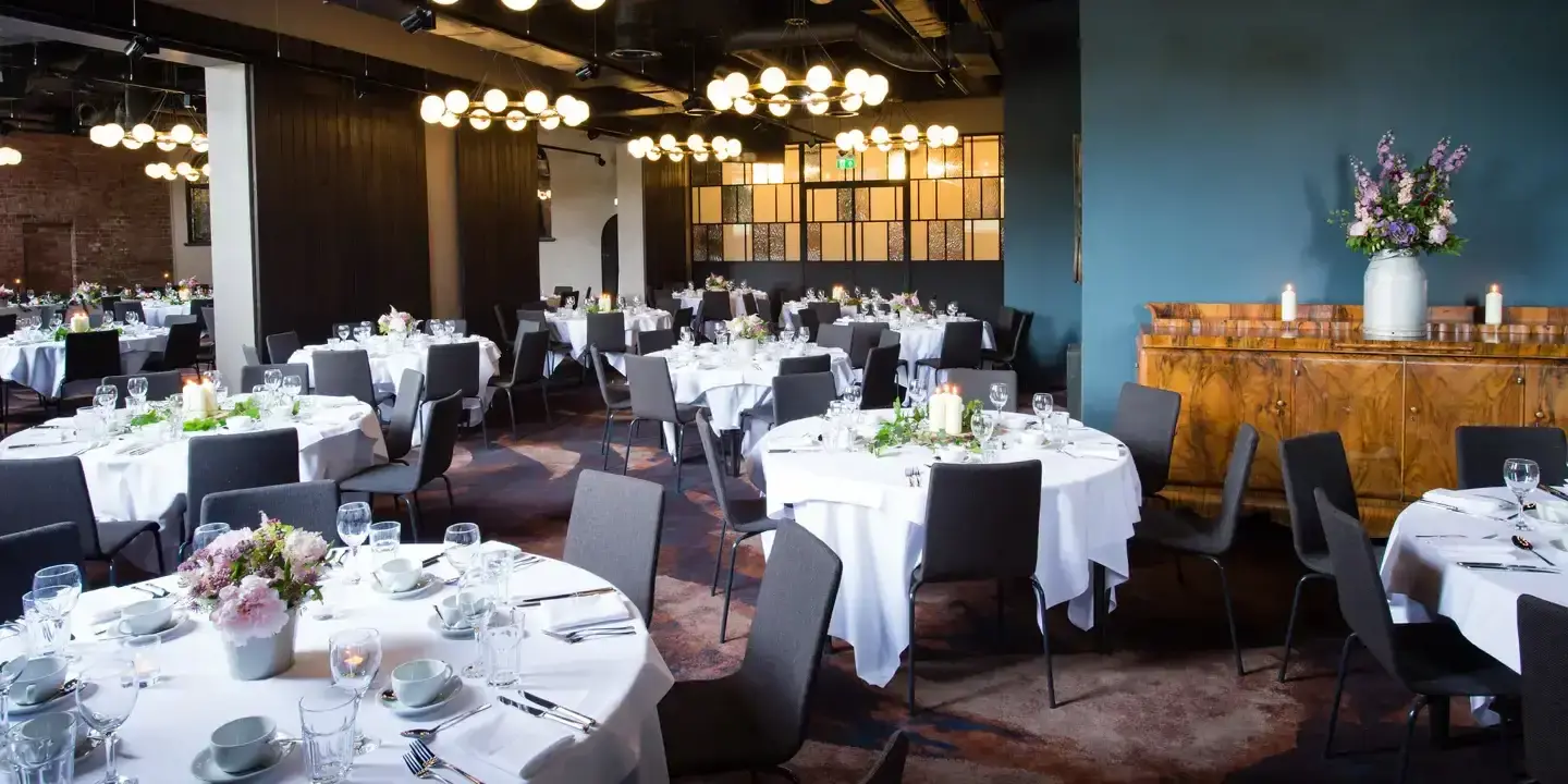 A restaurant arranged with elegantly set tables and chairs for a delightful dinner experience.