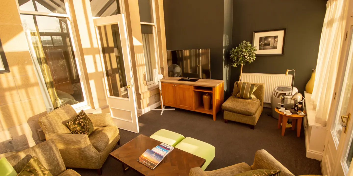 A well-furnished living room featuring a flat-screen TV.