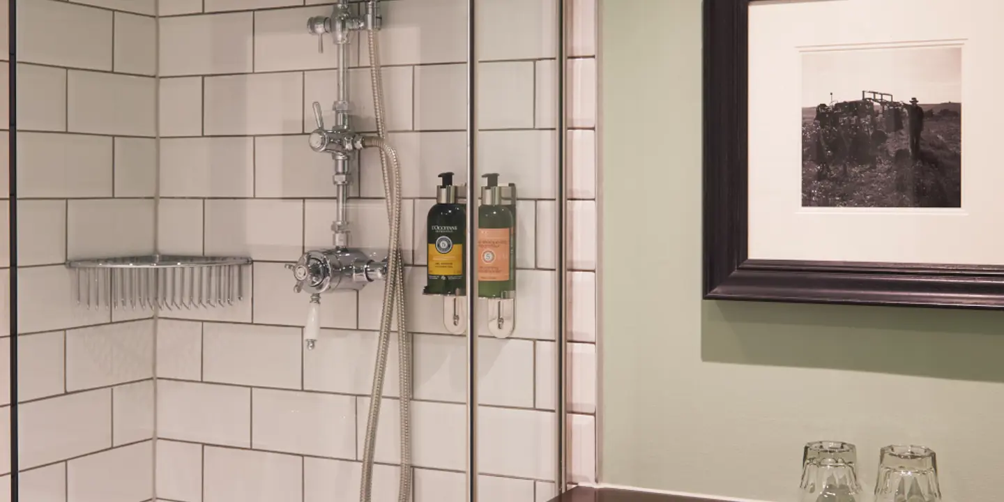 A bathroom featuring shower over bath