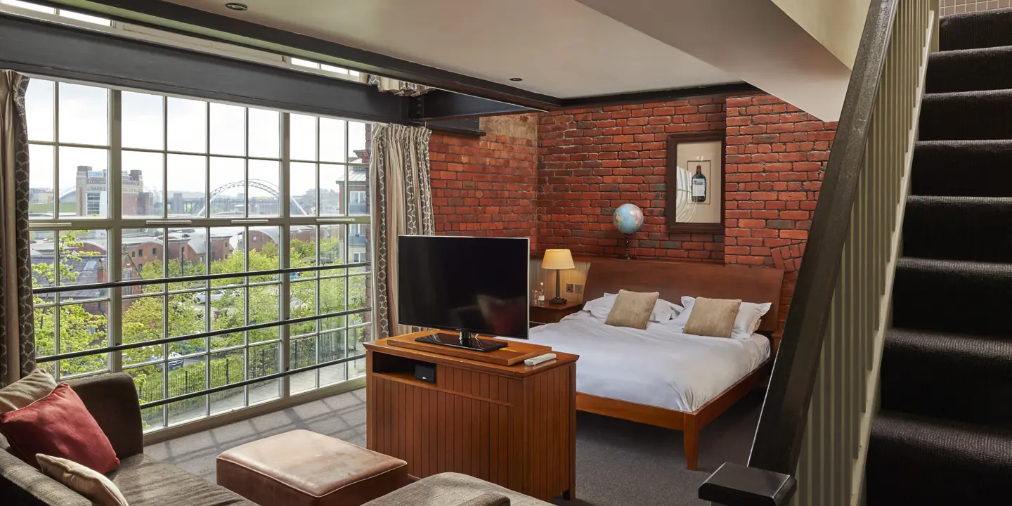 Bedroom featuring a comfortable bed and television.