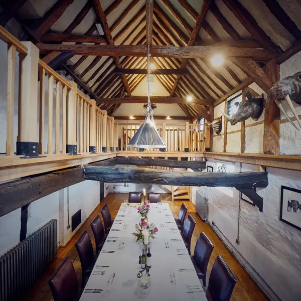 A dining room featuring a spacious table and chairs.