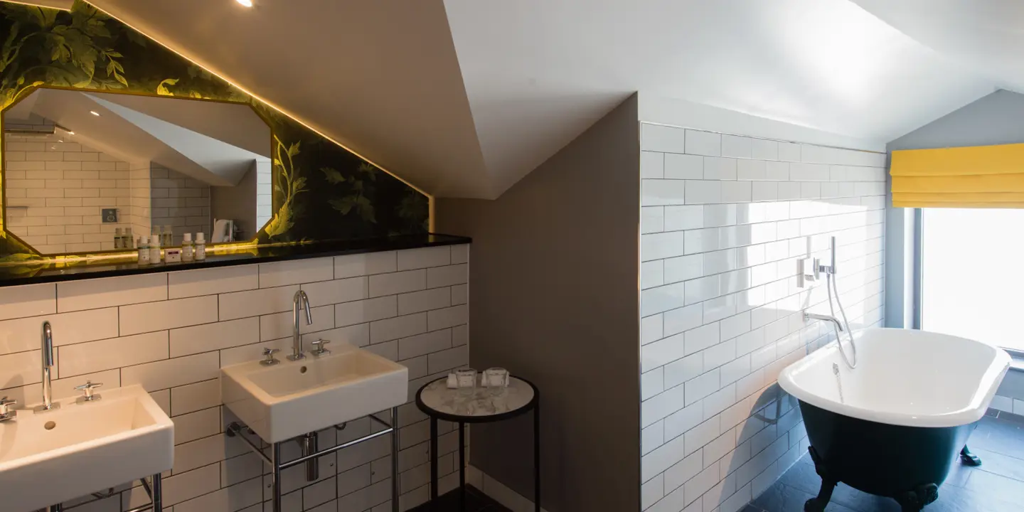 Bathroom featuring two sinks and a bathtub