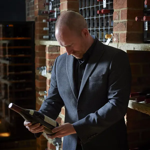 Sommelier choosing a wine from wine cellar