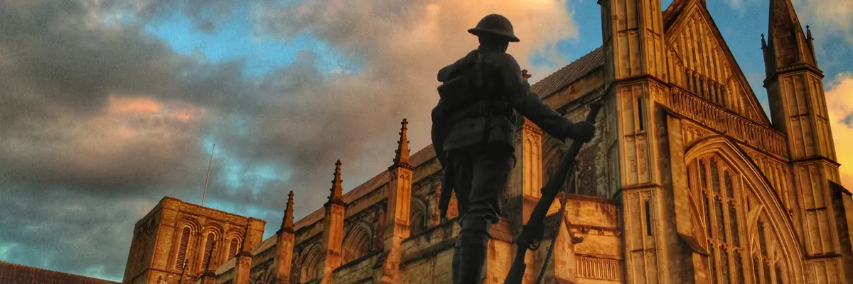 Statue of a soldier in front of a church.