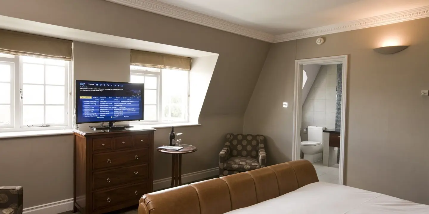 Bedroom featuring a bed, dresser, and television.