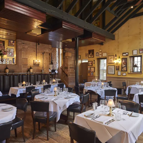 A restaurant featuring tables, chairs, and wall decorations.