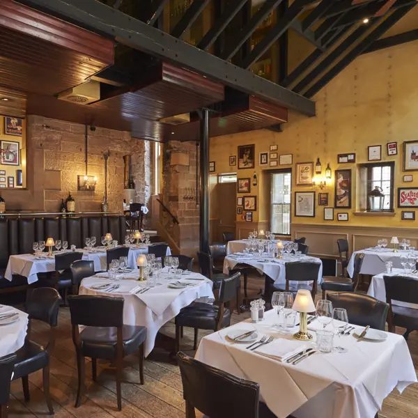 A restaurant featuring tables, chairs, and wall decorations.