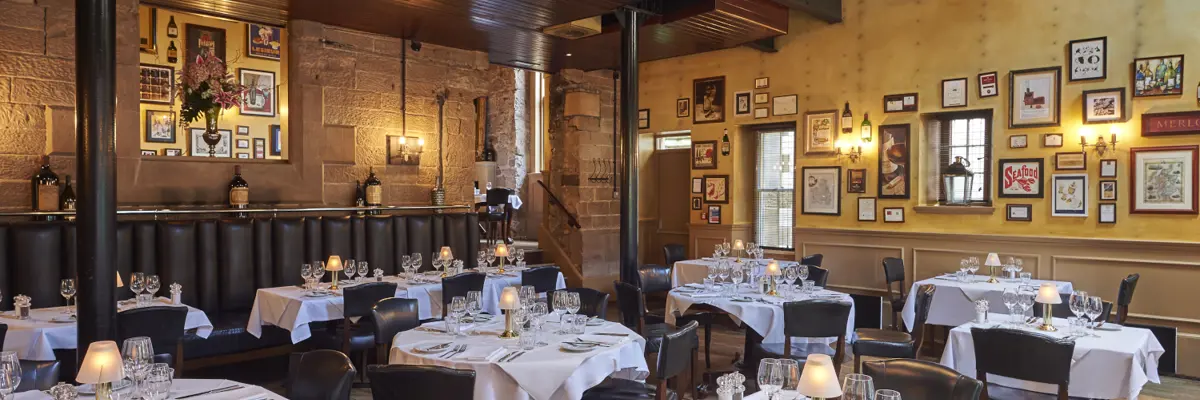 A restaurant featuring tables, chairs, and wall decorations.