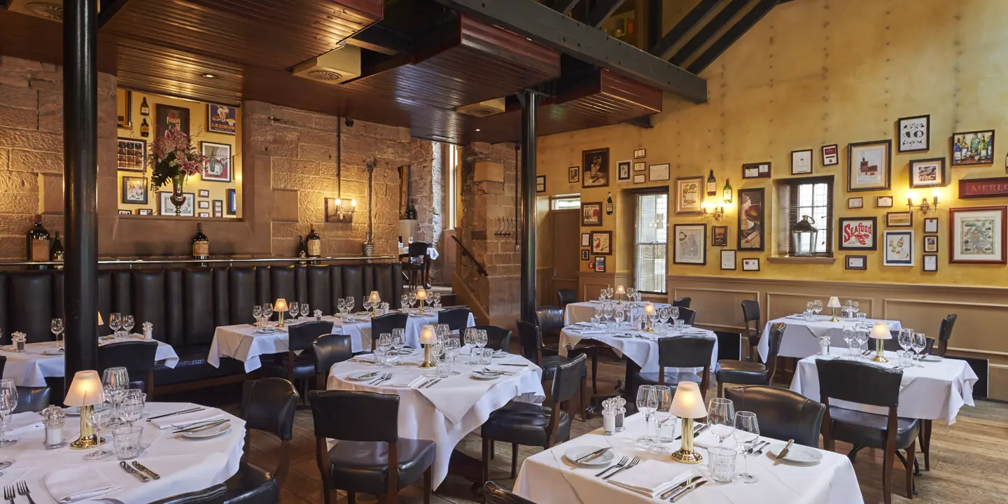 A restaurant featuring tables, chairs, and wall decorations.