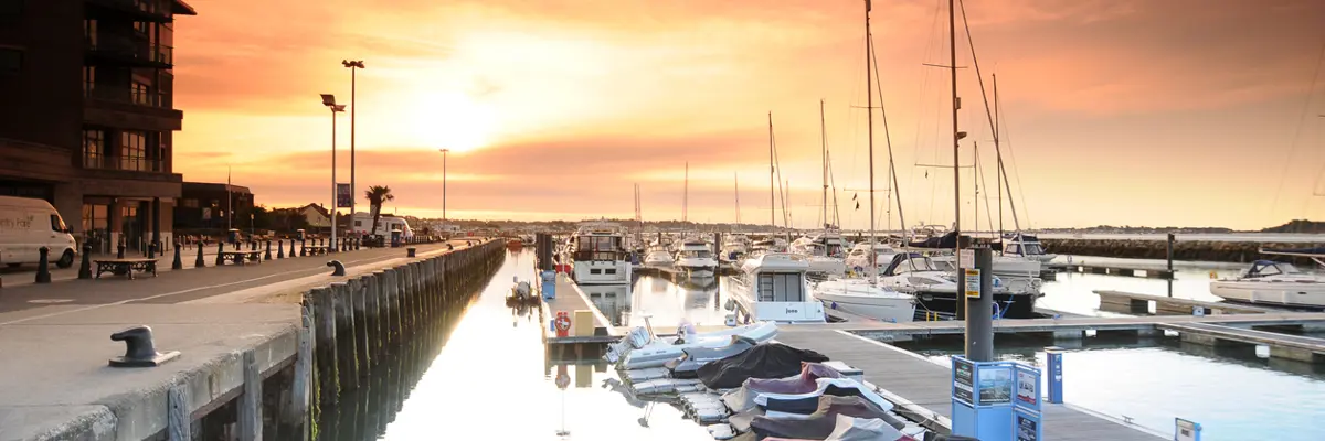 A cluster of boats moored at a dock.