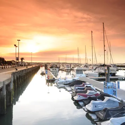 A cluster of boats moored at a dock.