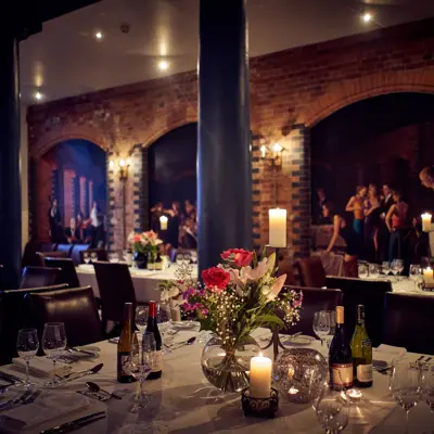 A beautifully arranged table adorned with elegant wine glasses and flickering candles.