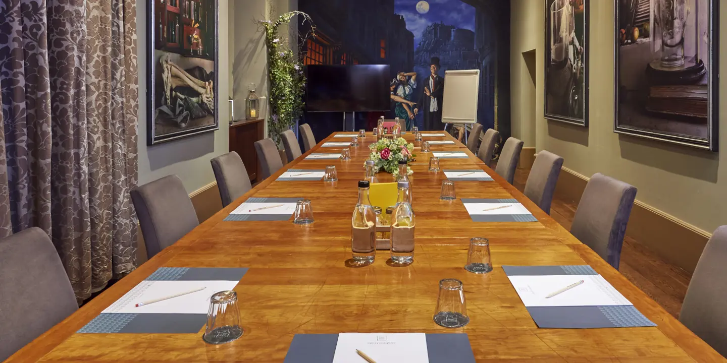 Modern meeting room set up with wooden table, mural background and wall art