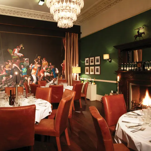 Dining room featuring a prominent wall painting.