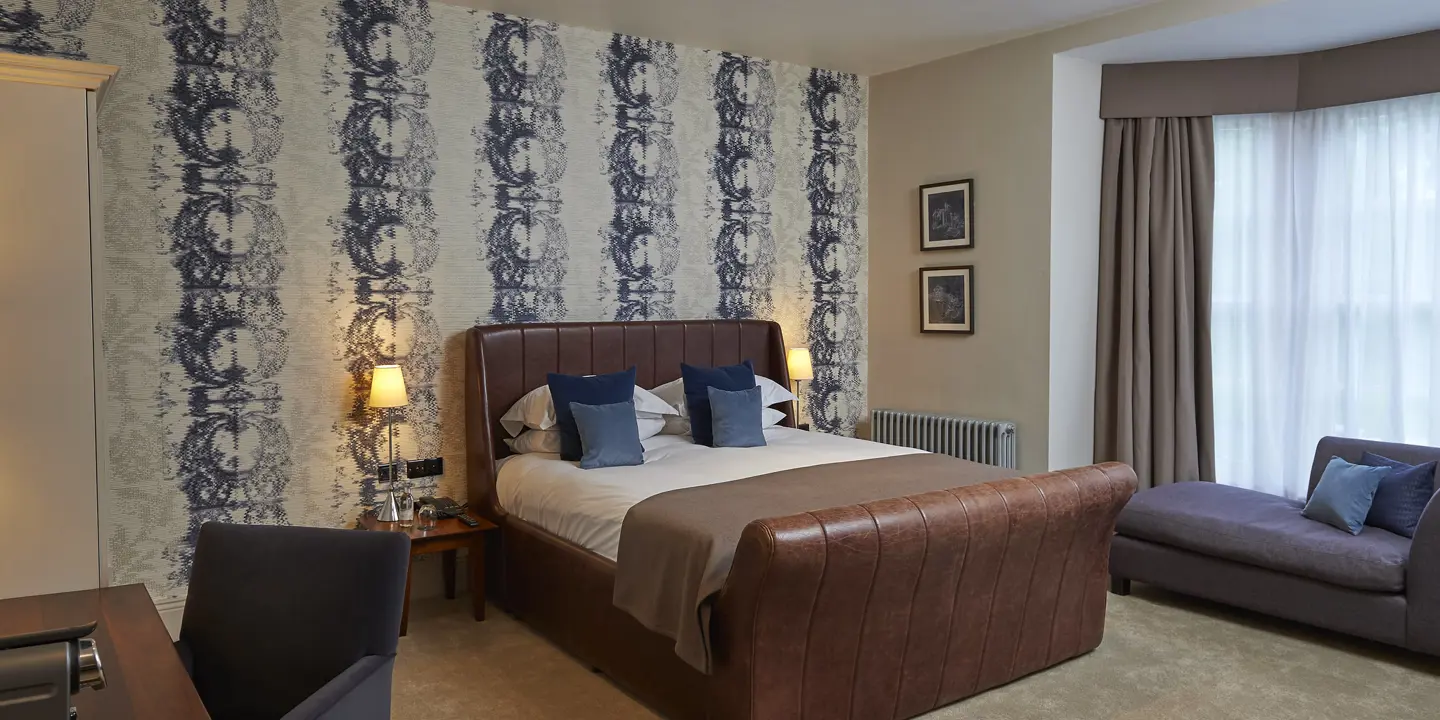 Brown leather bed in a spacious bedroom