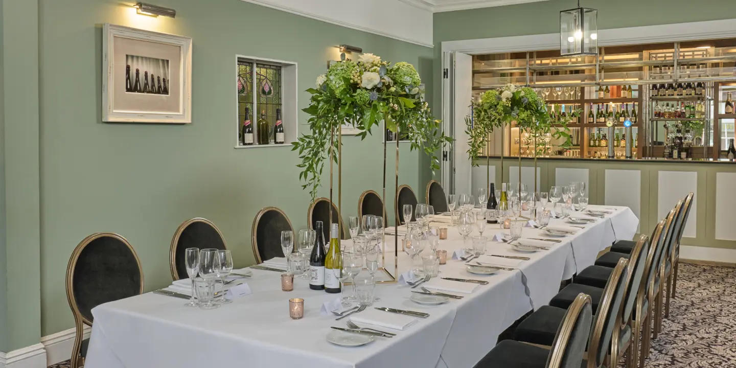 Table set for a wedding breakfast with candles and flowers.