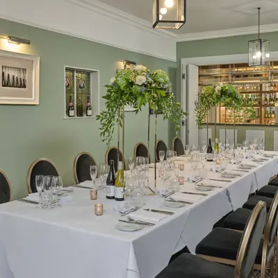 Table set for a wedding breakfast with candles and flowers.