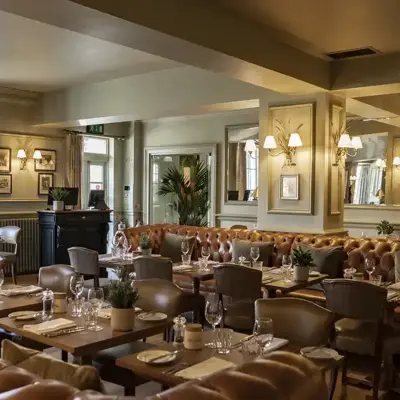 A spacious dining room filled with numerous tables and chairs.