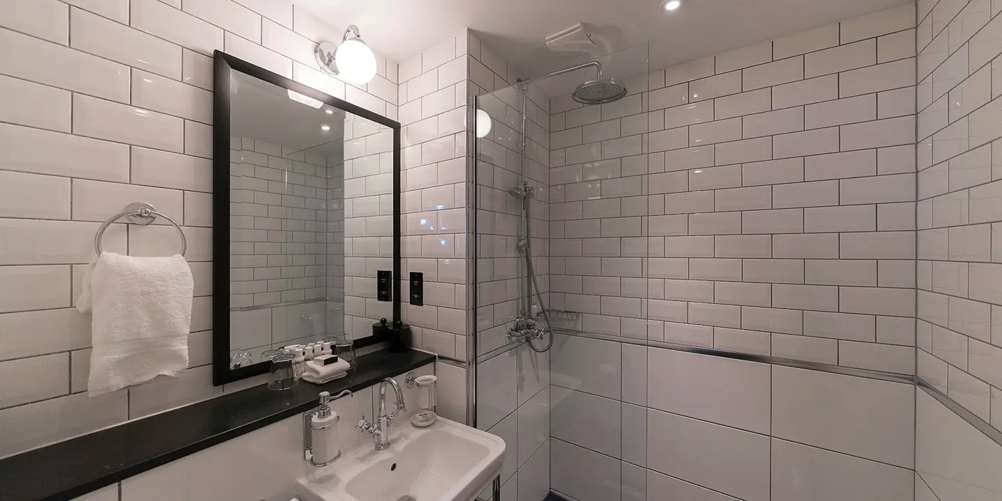 Bathroom featuring a sink, mirror, and shower.