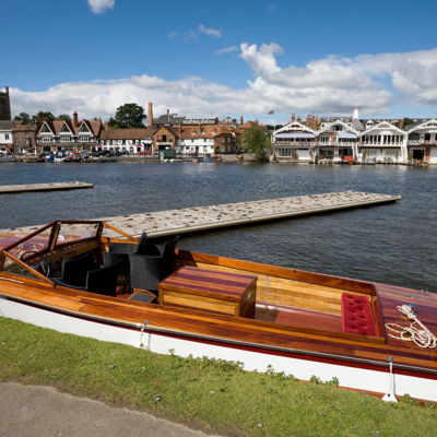 A wooden boat moored at a harbor dock.