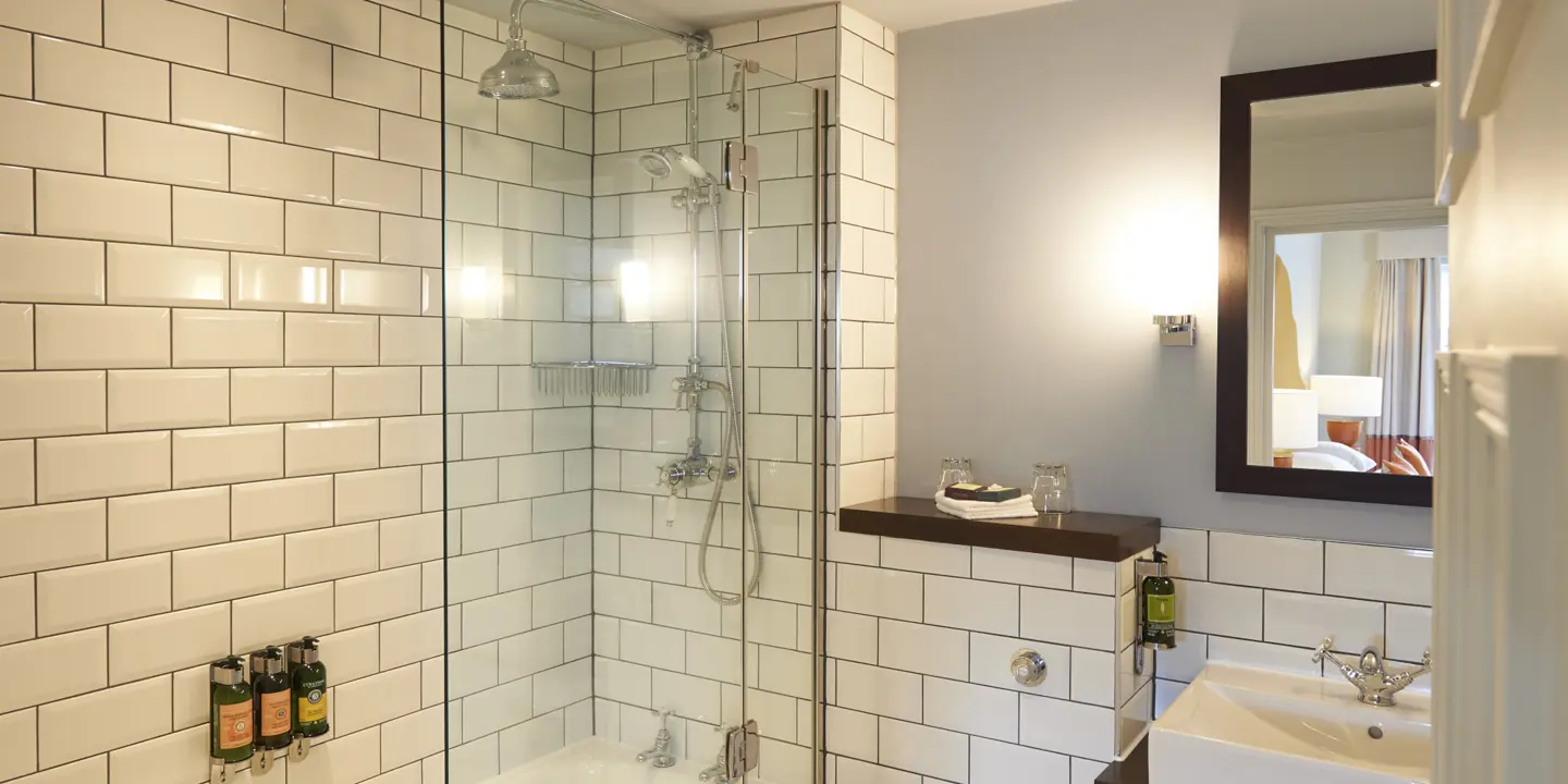 Bathroom featuring a shower, sink, and toilet.