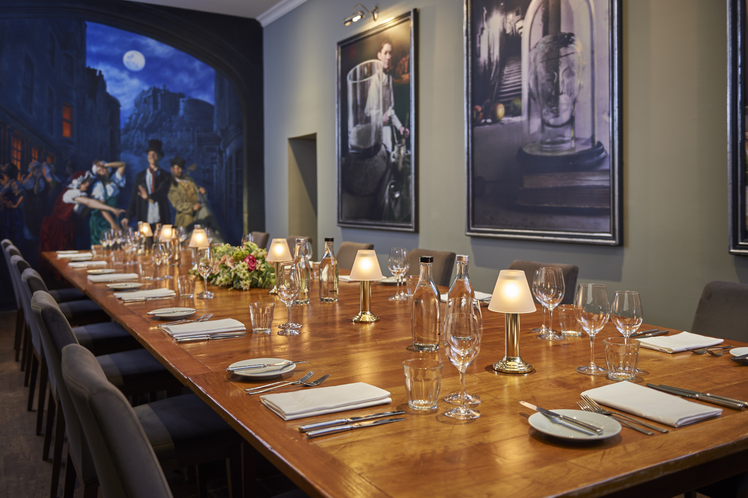 Wooden table adorned with wine glasses and bottles of wine.