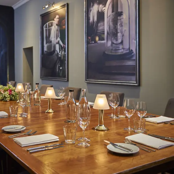 Wooden table adorned with wine glasses and bottles of wine.