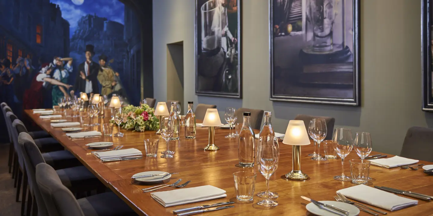 Wooden table adorned with wine glasses and bottles of wine.