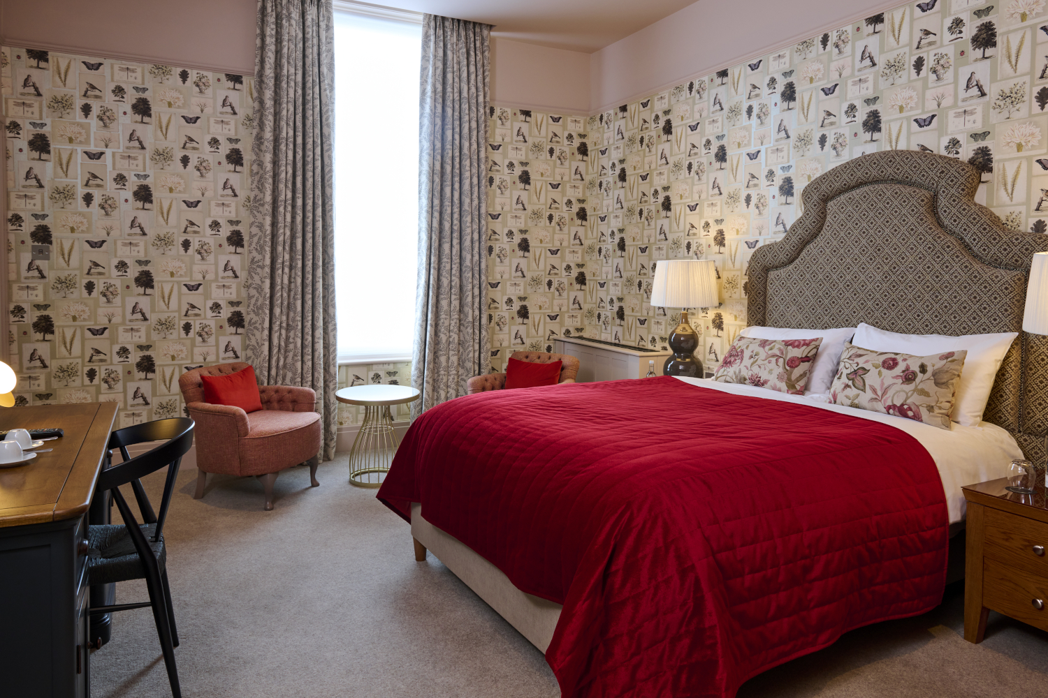 A neutral bedroom with a double bed in the centre