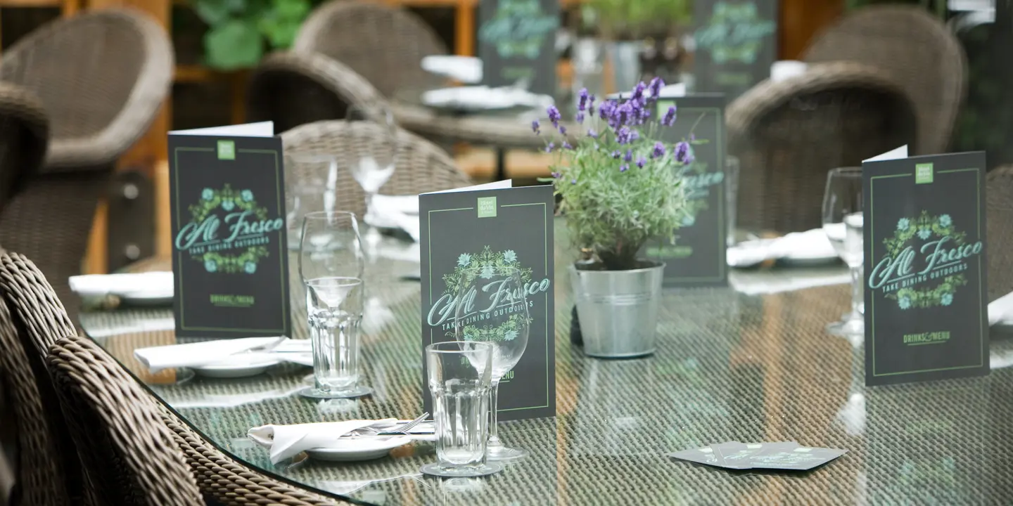 A table adorned with neatly arranged place settings and elegant place cards.