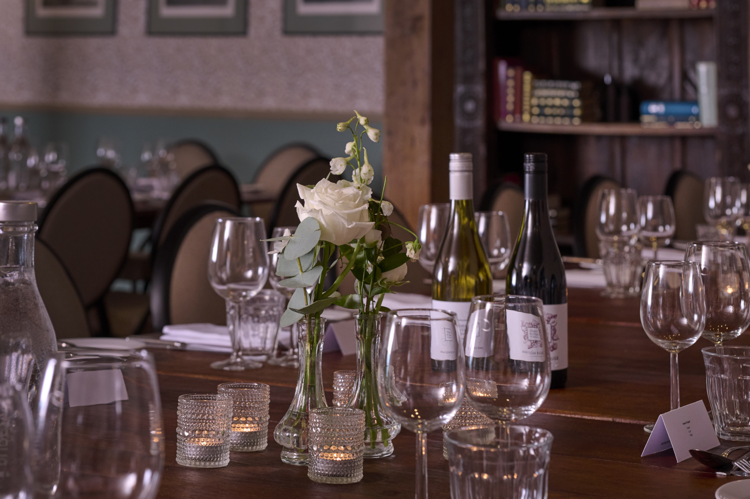 A dining room featuring a spacious table adorned with sleek black chairs.
