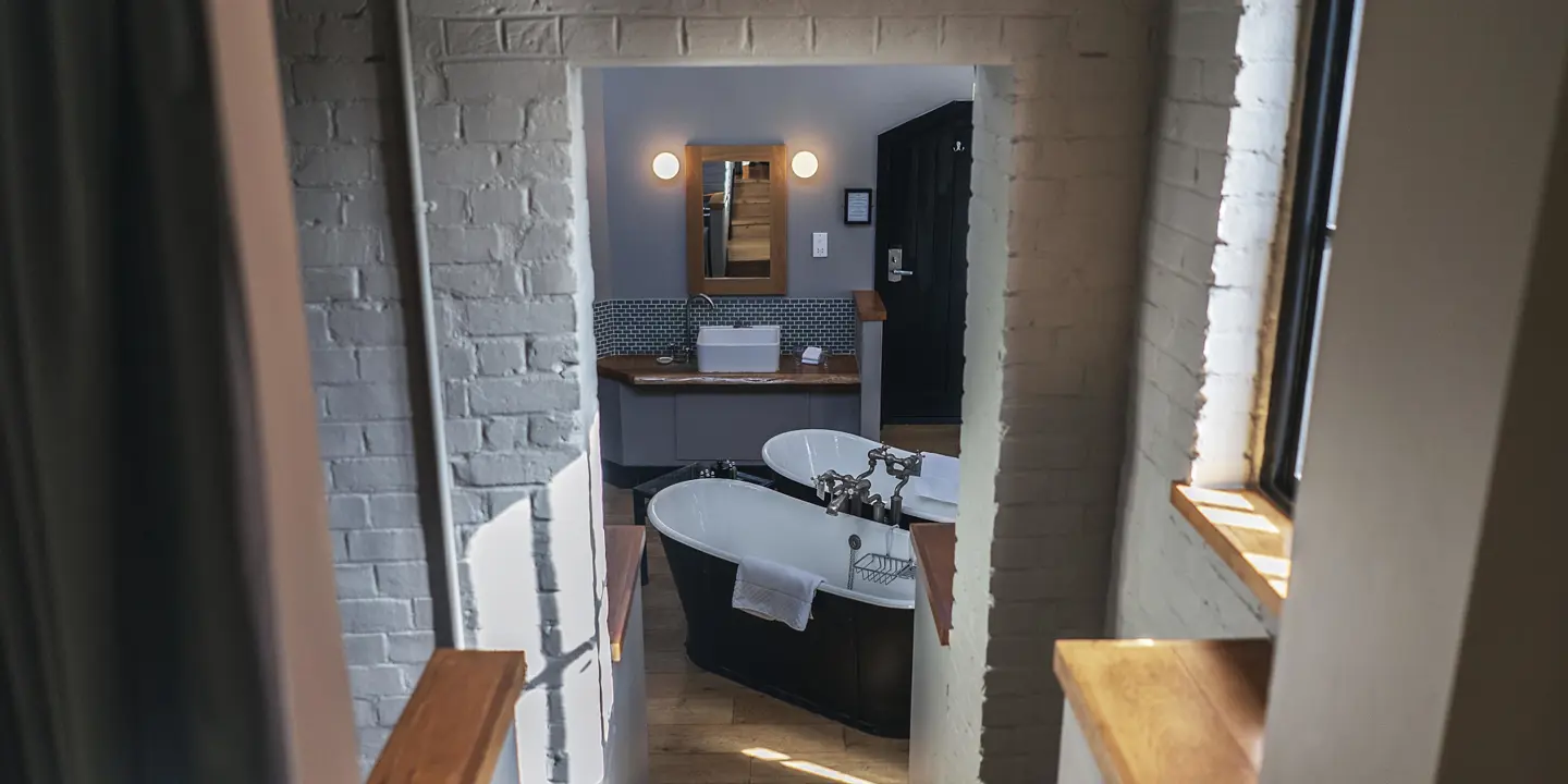 Bathroom featuring a bathtub and window.