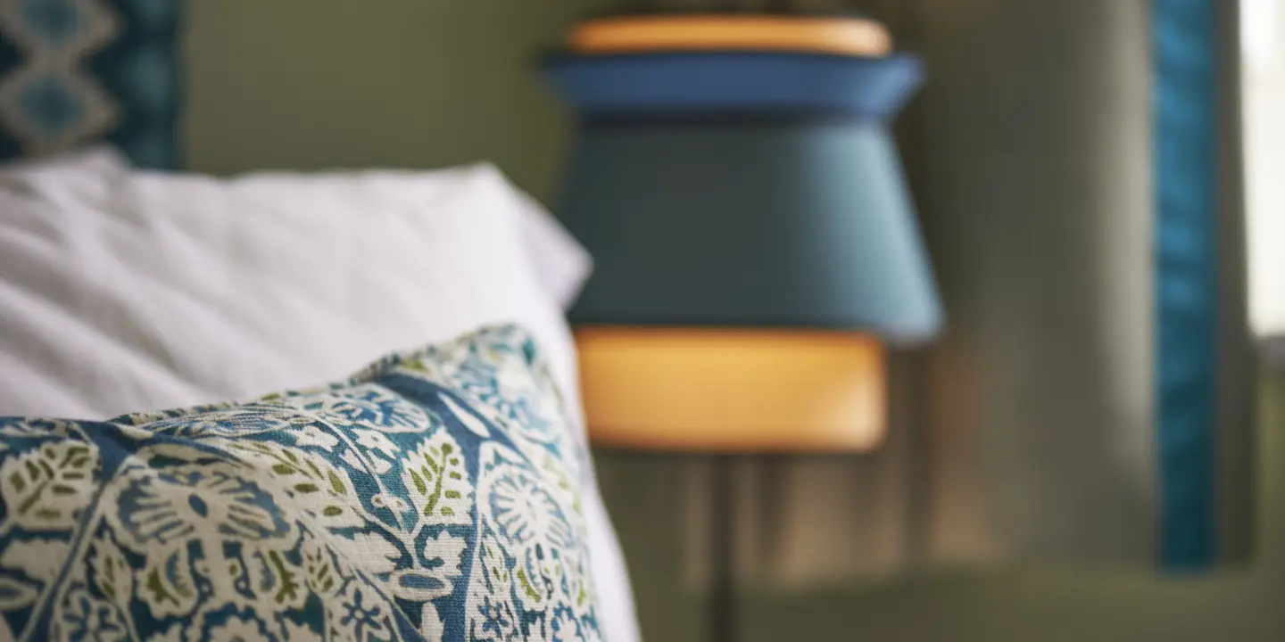 A close-up view of a pillow resting on a bed.