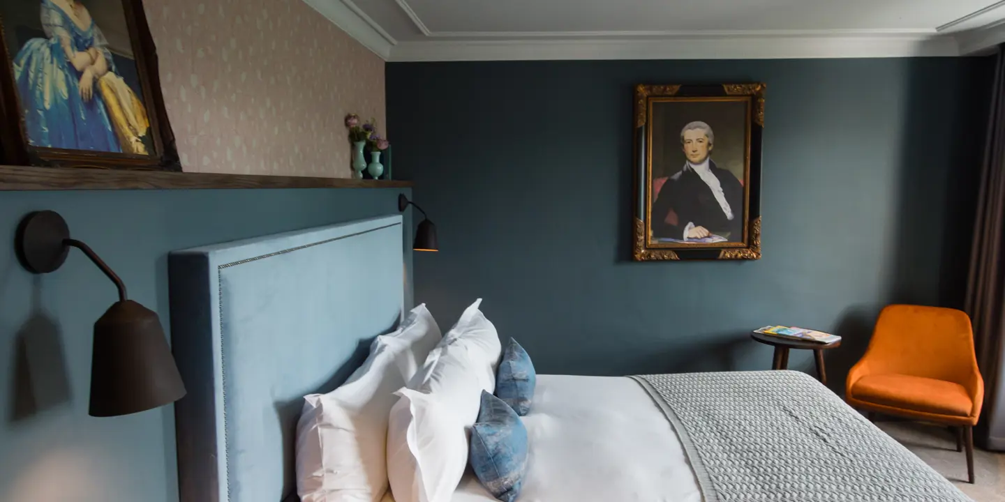 Bedroom featuring a comfortable bed and an elegant wall painting.