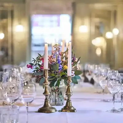 A beautifully arranged table adorned with elegant wine glasses and flickering candles.