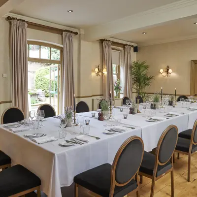 A dining room featuring a spacious table and chairs.