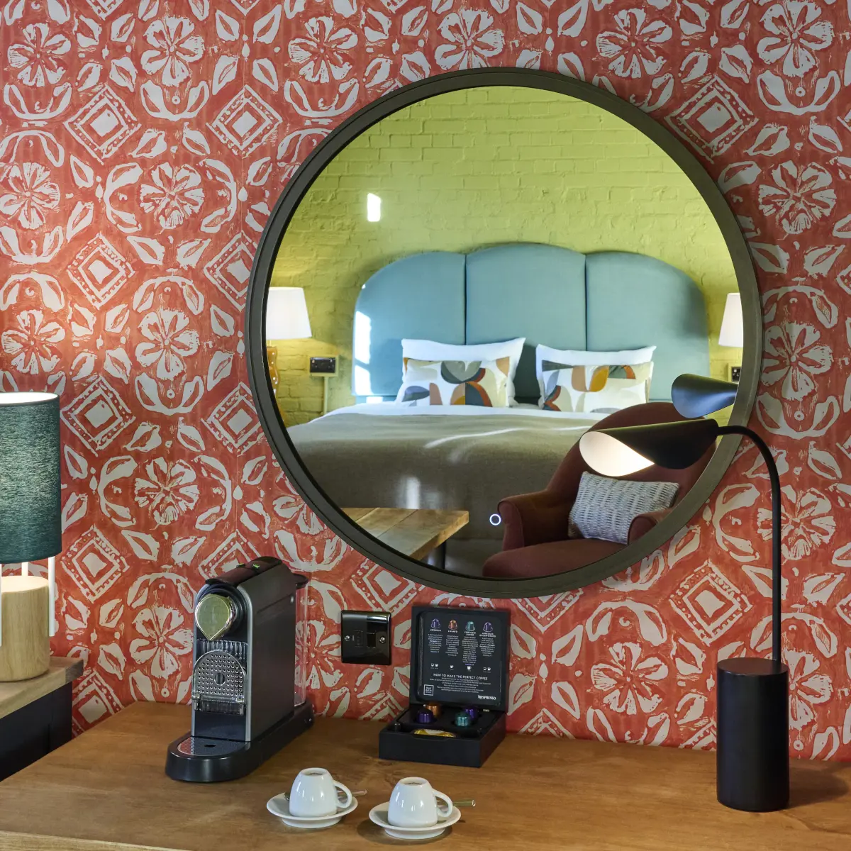 Hotel room featuring a comfortable bed and two chairs.
