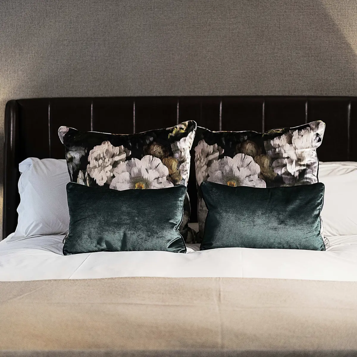 Bed with two pillows and two lamps.