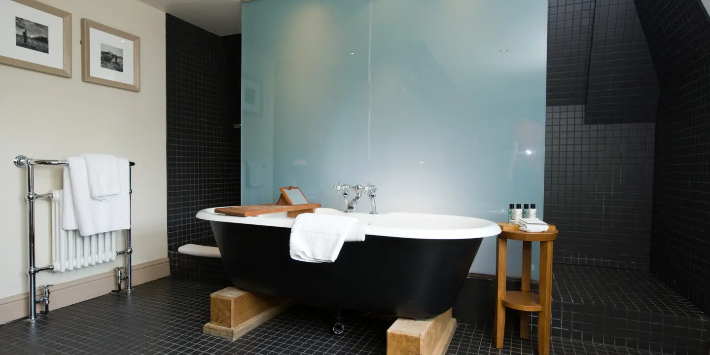 Black and white bathtub in a bathroom.