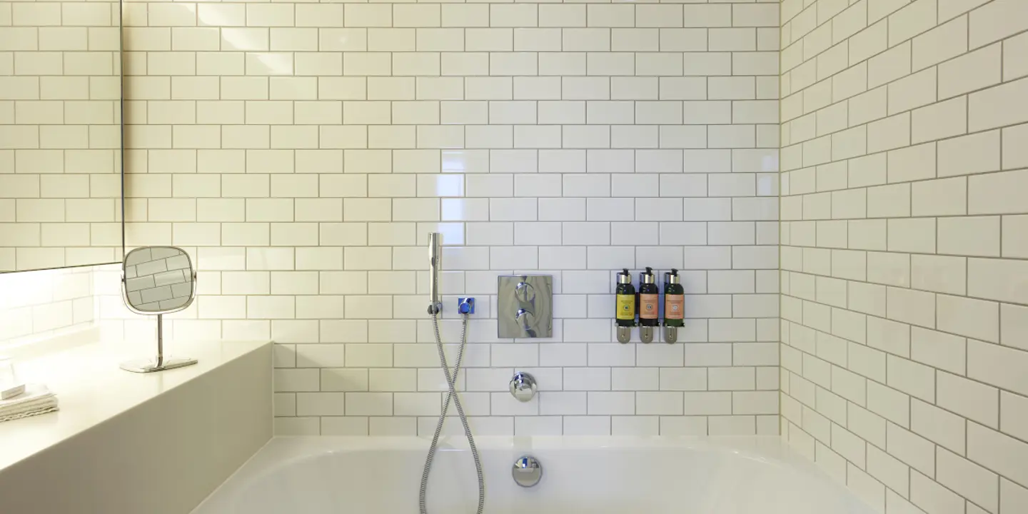 Bathroom featuring a bathtub, sink, and mirror.