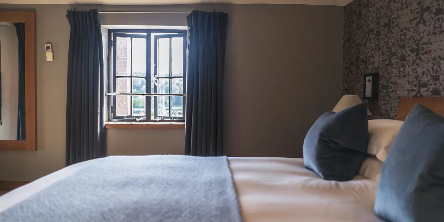 Spacious bedroom featuring a generously sized bed and a window.