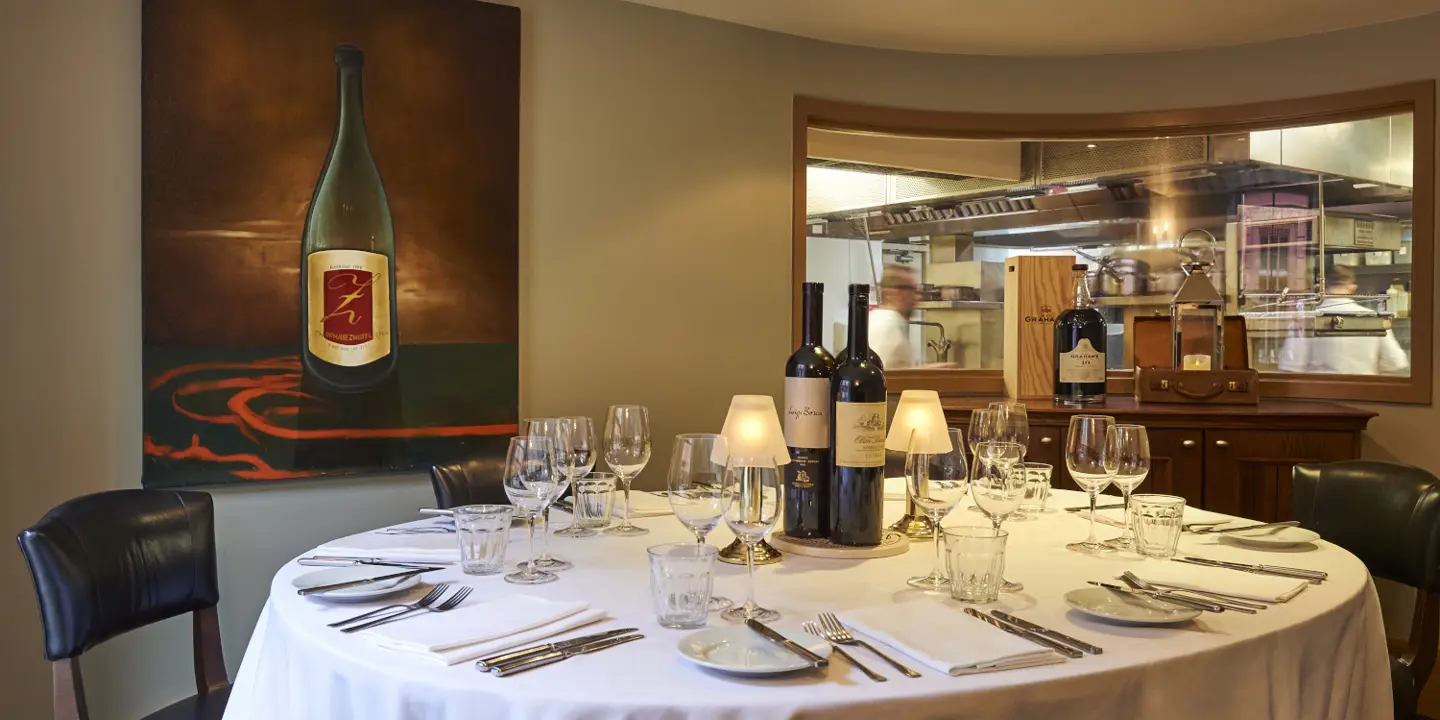 A beautifully arranged table adorned with elegant wine glasses and flickering candles.