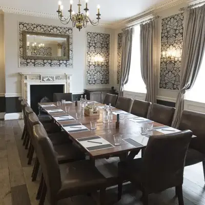 A Meeting room with long table and chandelier