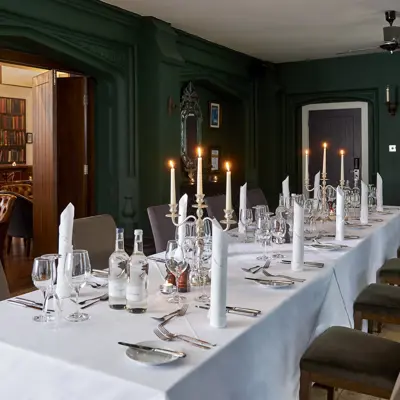 A dining room featuring a spacious table and chairs.